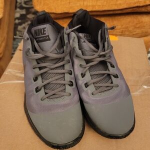 This is a pair of Nike Air Versitile Nubuck basketball shoes in grey and black.